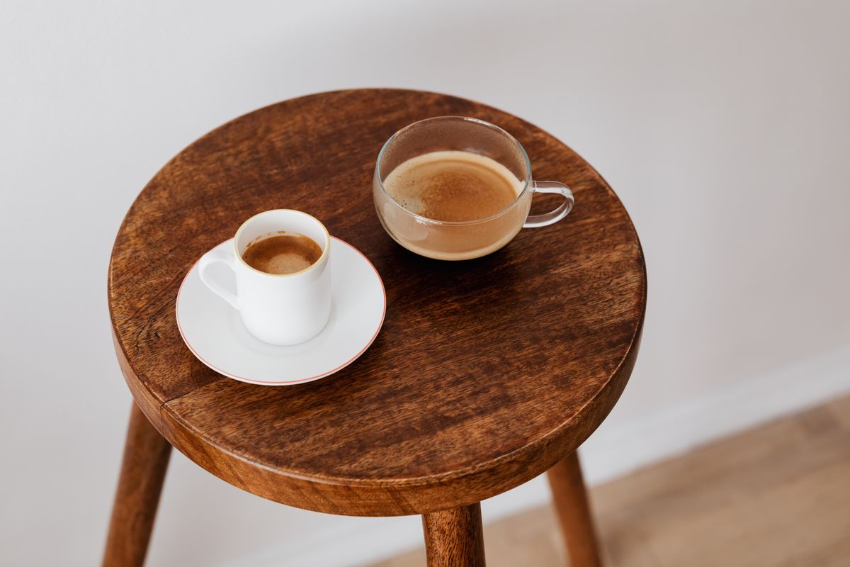 木製の丸い台に置かれた二つのコーヒーカップ